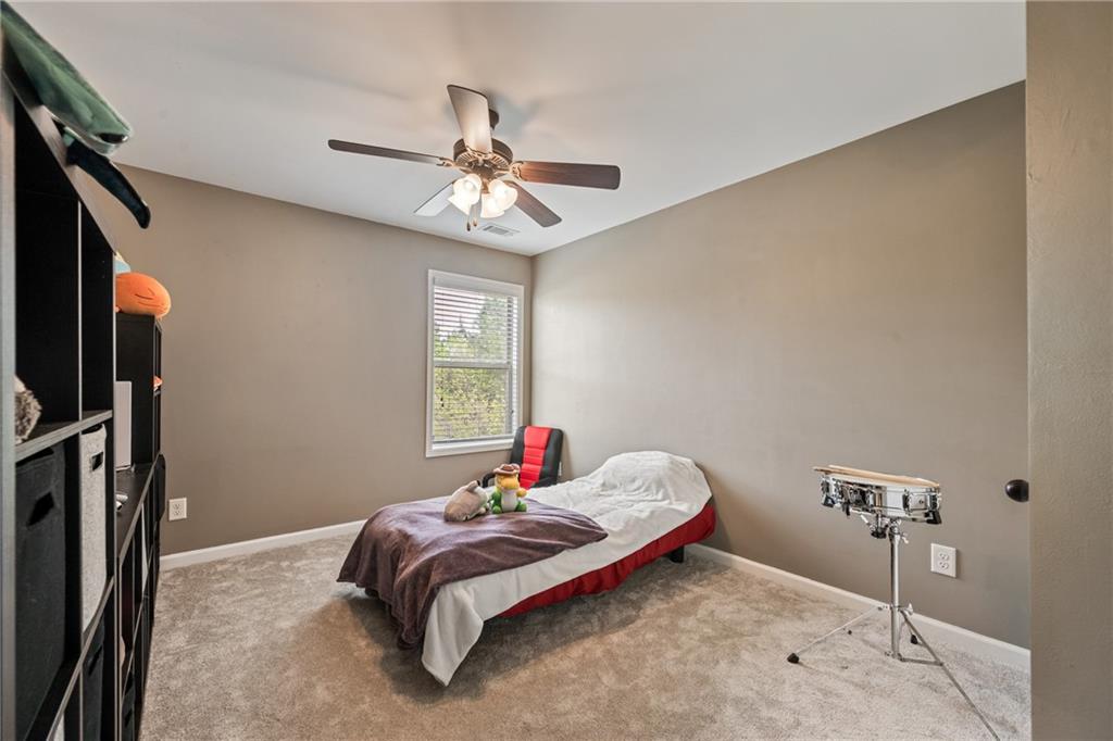 555 Evergreen Way Jefferson, GA 30549 - Photo 42 of 69 a bedroom with a bed and a chandelier