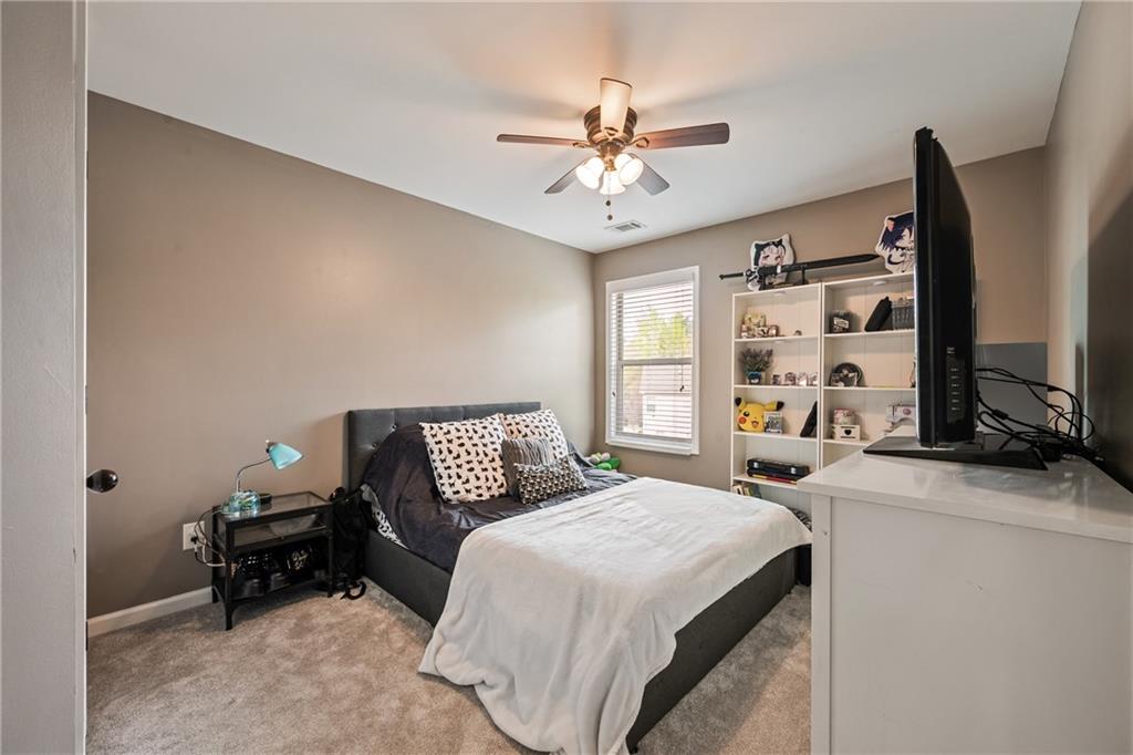 555 Evergreen Way Jefferson, GA 30549 - Photo 44 of 69 a bedroom with a bed and a flat screen tv