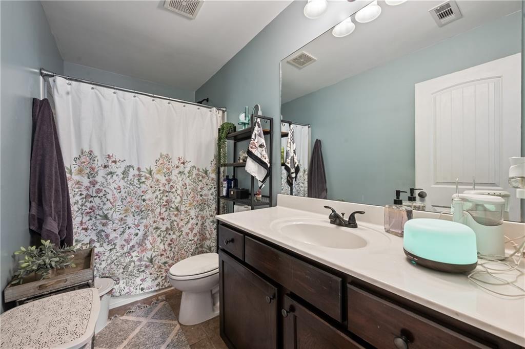 555 Evergreen Way Jefferson, GA 30549 - Photo 45 of 69 a bathroom with a granite countertop sink toilet and shower