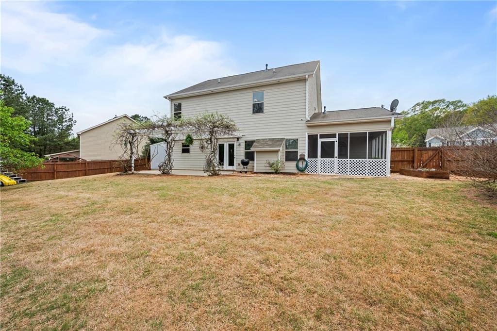 555 Evergreen Way Jefferson, GA 30549 - Photo 6 of 69 a view of a house with a big yard and large trees