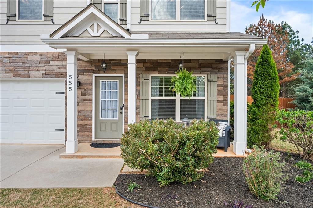 555 Evergreen Way Jefferson, GA 30549 - Photo 7 of 69 a front view of a house with garden
