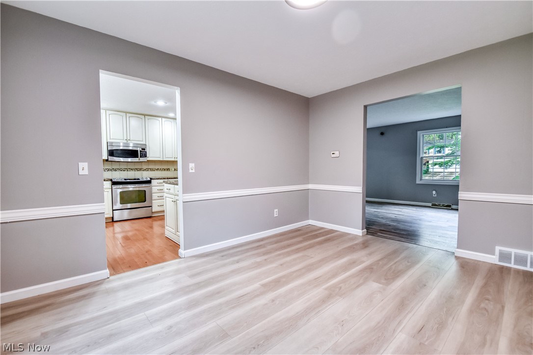 8242 Starburst Road Mentor, OH 44060 - Photo 33 of 37 Light wood-finish flooring complements the neutral wall paint and white baseboards