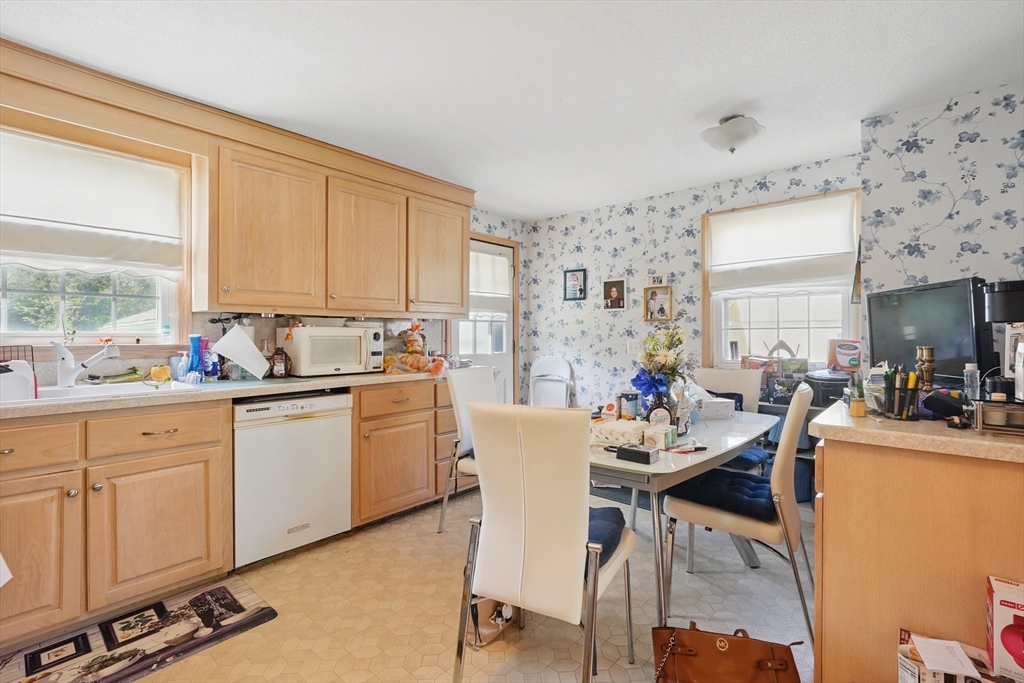 153 Maple Road Longmeadow, MA 01106 - Photo 12 of 29 a kitchen with sink cabinets and dining table chair