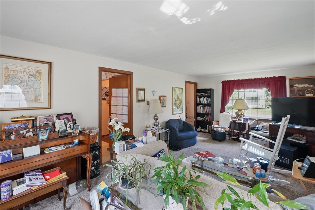 153 Maple Road Longmeadow, MA 01106 - Photo 8 of 29 a living room with furniture toys and a flat screen tv