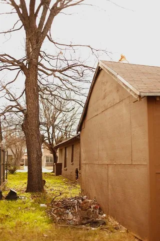 a view of a house with snow on the tree