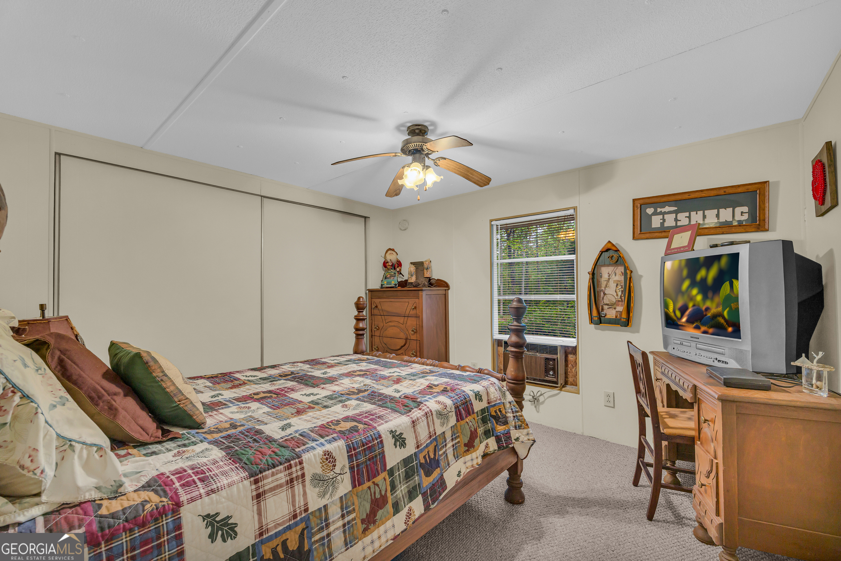 23 Wren Court Toccoa, GA 30577 - Photo 13 of 26 a bedroom with a bed and a flat tv screen on dresser