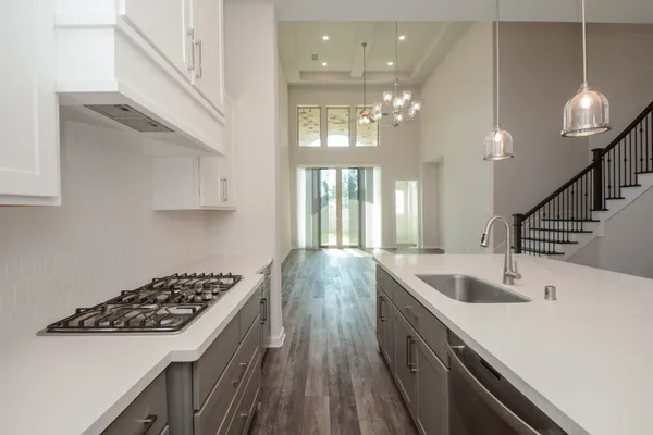 a kitchen with counter top space appliances and cabinets