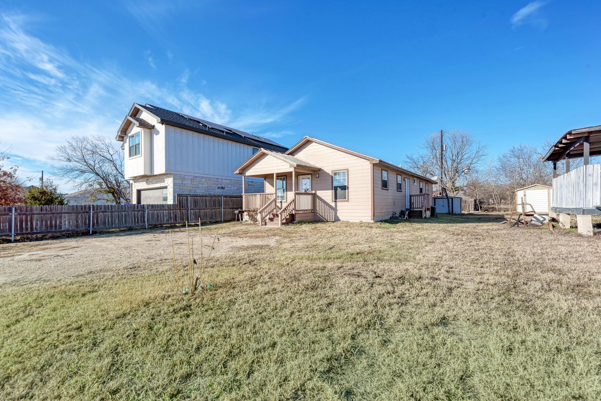 107 West Brenham Street Manor, TX 78653 - Photo 1 of 35 a view of a house with a yard