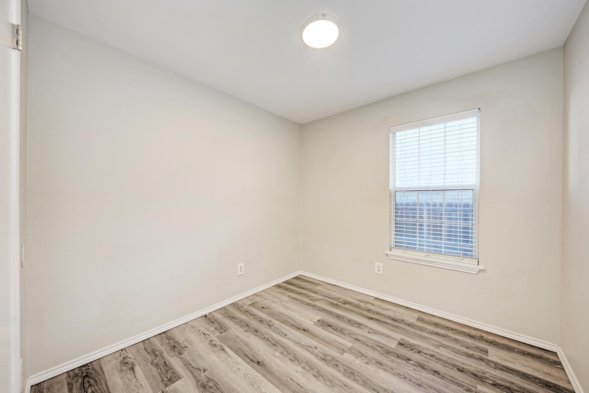 107 West Brenham Street Manor, TX 78653 - Photo 22 of 35 an empty room with a window