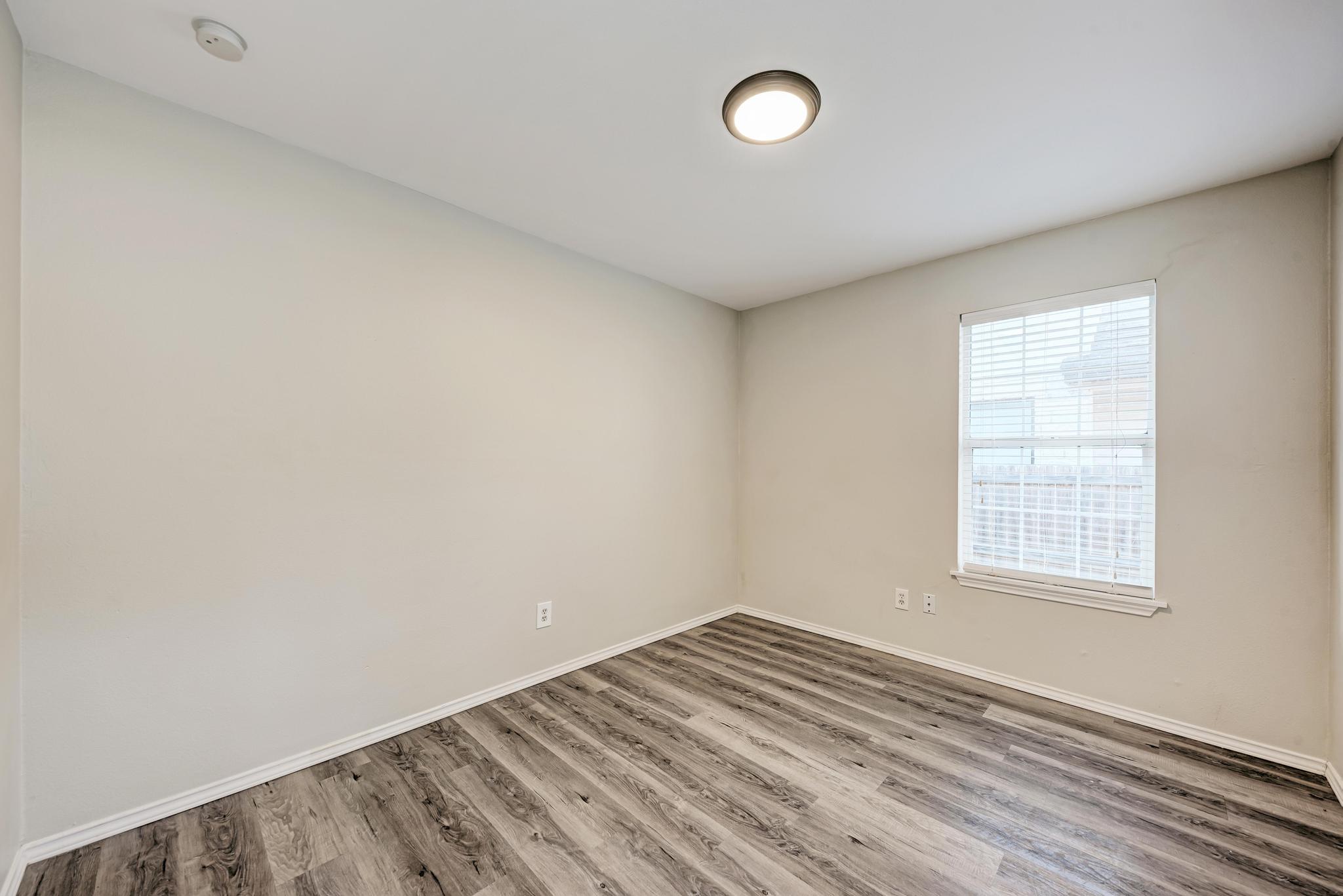 107 West Brenham Street Manor, TX 78653 - Photo 27 of 35 an empty room with a window