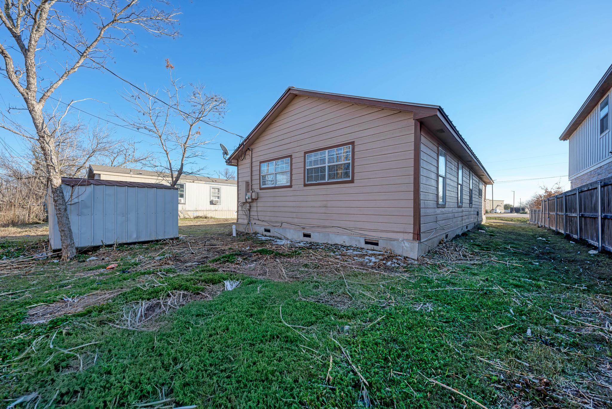 107 West Brenham Street Manor, TX 78653 - Photo 35 of 35 a backyard of a house with lots of green space