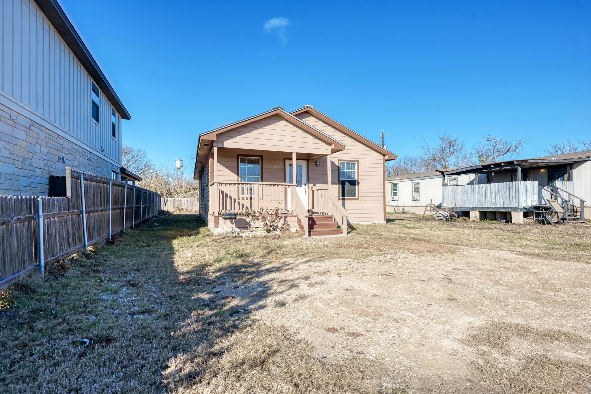 107 West Brenham Street Manor, TX 78653 - Photo 4 of 35 a view of a house with a yard