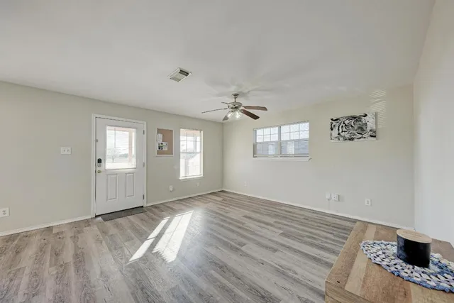 wooden floor in an empty room with a window