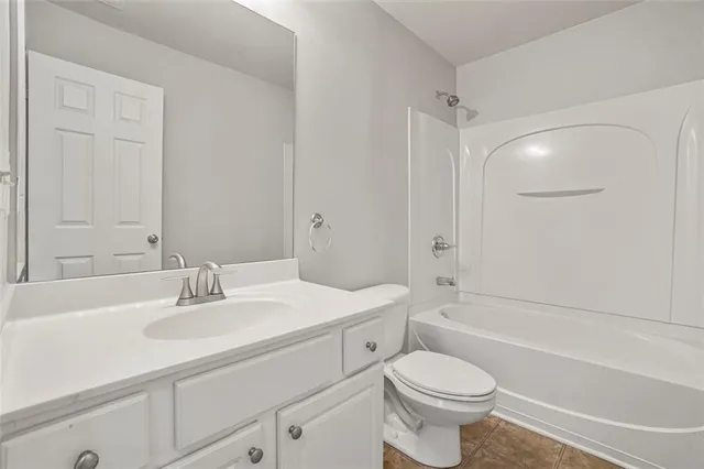 a bathroom with a sink toilet vanity and shower