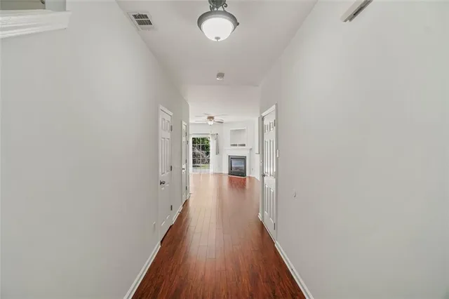 a view of a hallway with wooden floor and staircase