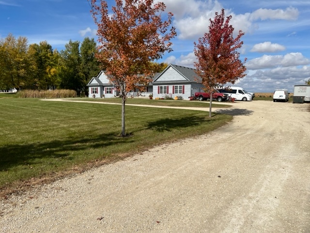 3322 Chicago Road Paw Paw, IL 61353 - Photo 3 of 37 a view of street with houses and trees in the background