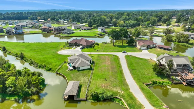 an aerial view of a residential houses with outdoor space and street view