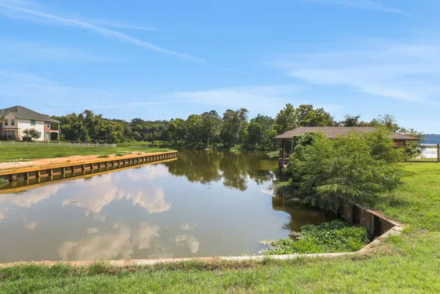 a view of a lake with houses in the background