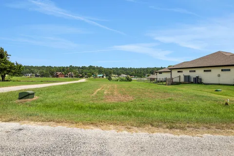 a view of a lake with houses in the back
