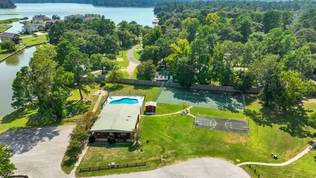 a view of a tennis ground with a large trees