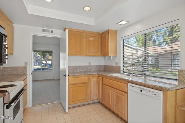 a kitchen with a sink stove and cabinets