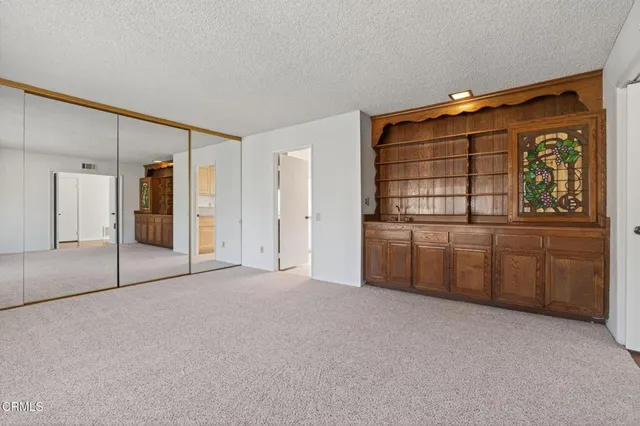 a big room with closet and windows
