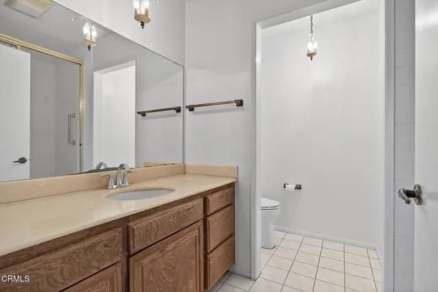 a bathroom with a sink a toilet a shower and a mirror