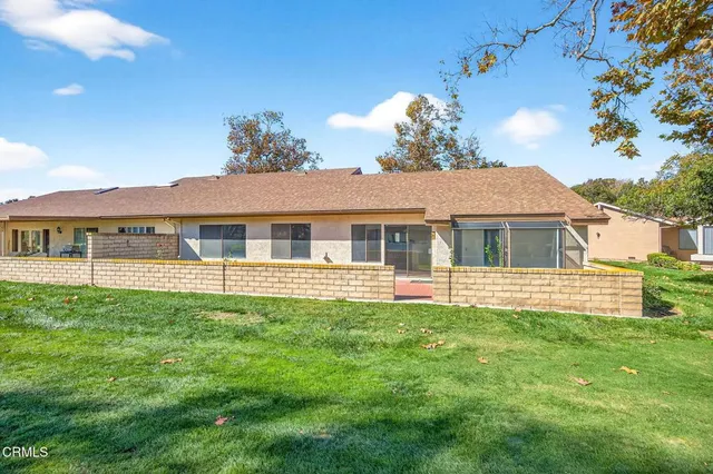 a view of a house with yard and tree s