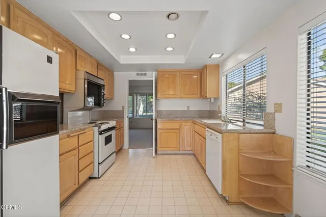 a large kitchen with stainless steel appliances granite countertop a large counter top stainless steel appliances and cabinets