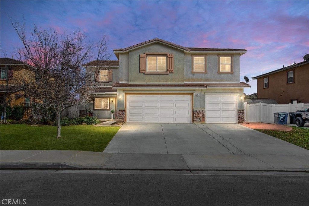 4423 Candelaria Way Perris, CA 92571 - Photo 1 of 42 a front view of a house with garden and parking