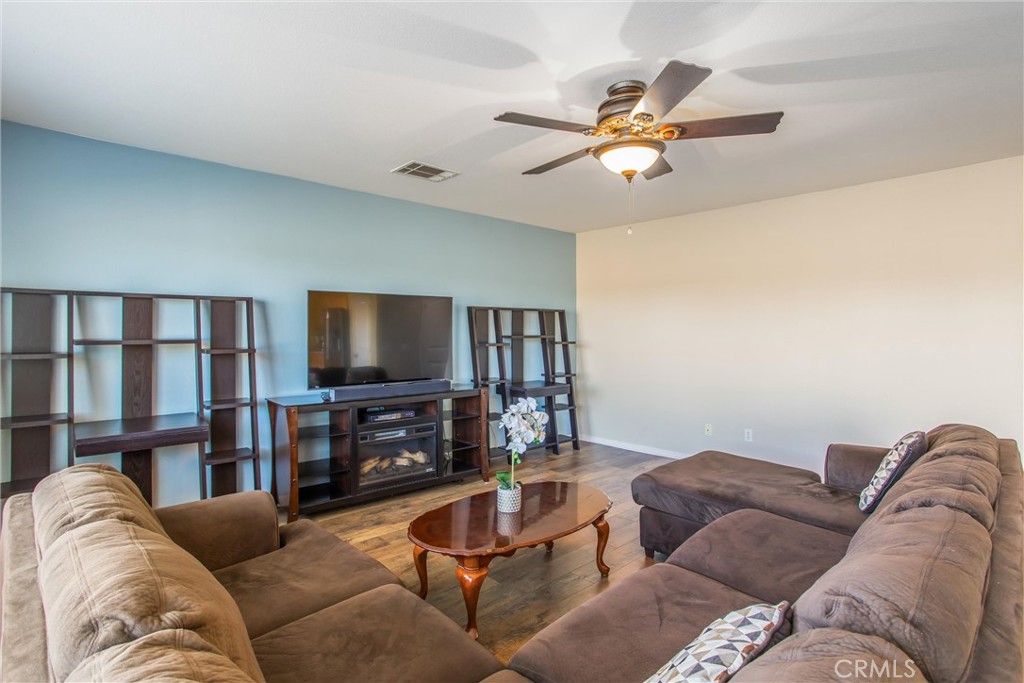 4423 Candelaria Way Perris, CA 92571 - Photo 15 of 42 a living room with furniture and a flat screen tv