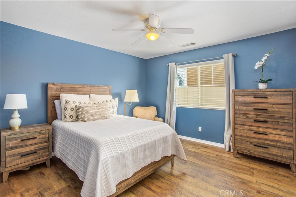 4423 Candelaria Way Perris, CA 92571 - Photo 18 of 42 a bedroom with a bed and a chandelier