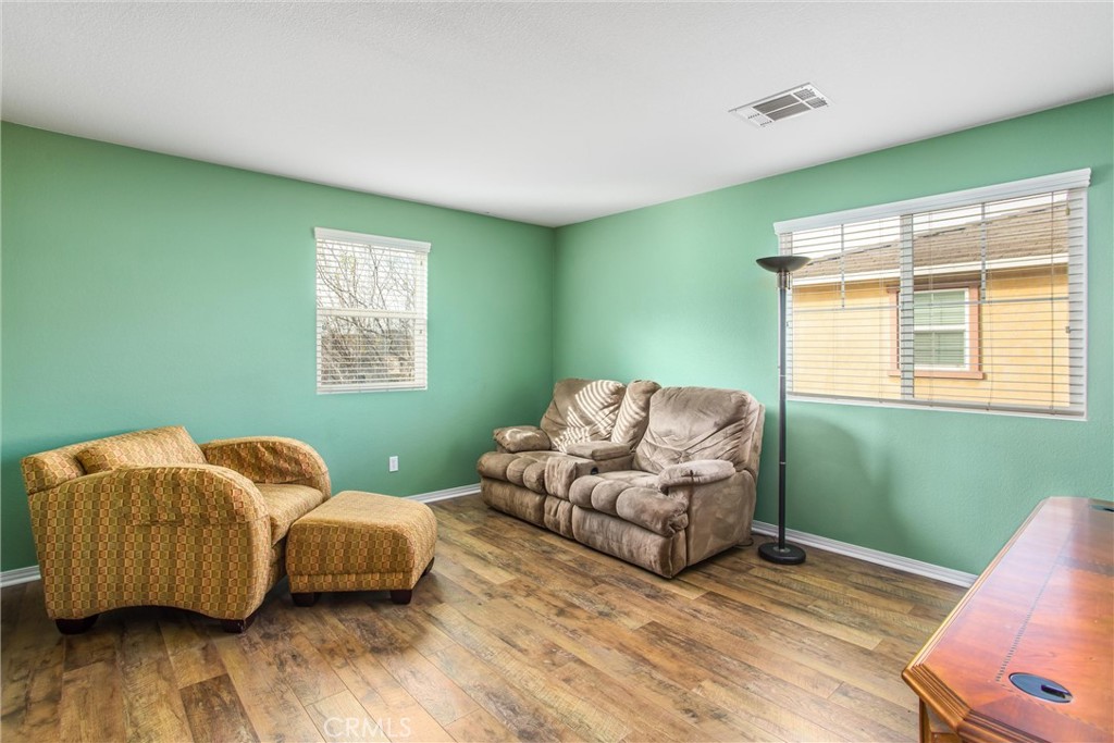 4423 Candelaria Way Perris, CA 92571 - Photo 22 of 42 a living room with furniture and a window