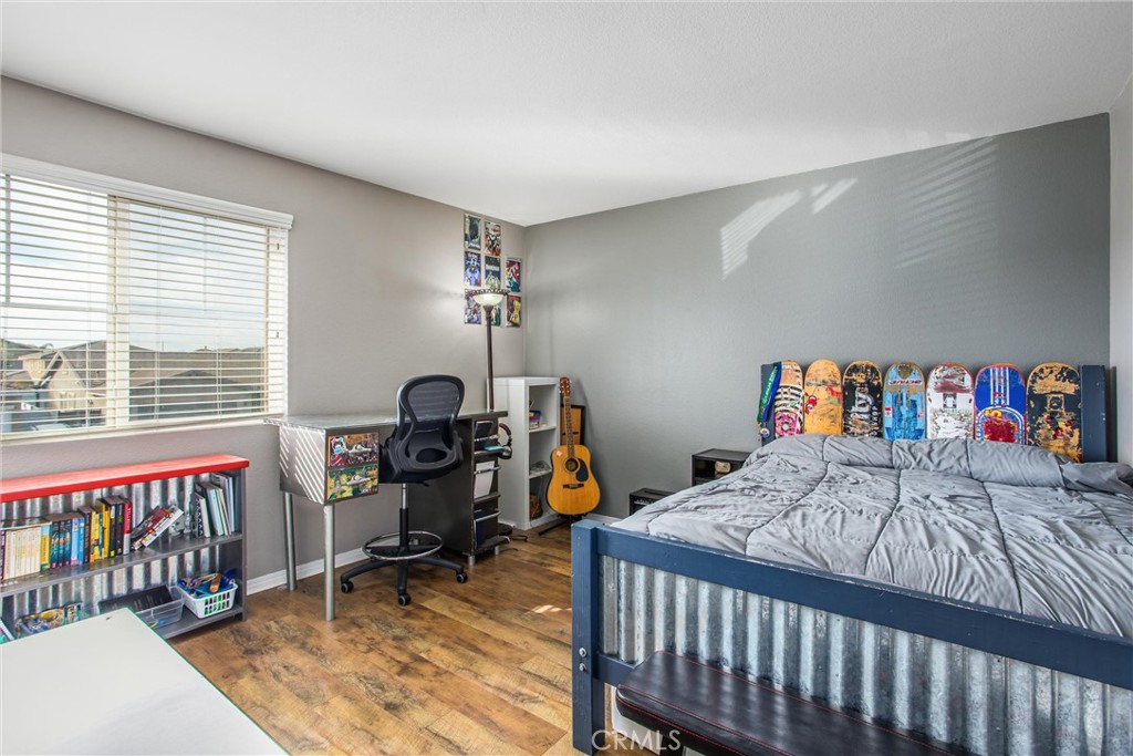 4423 Candelaria Way Perris, CA 92571 - Photo 25 of 42 a bedroom with a bed and a wooden floor