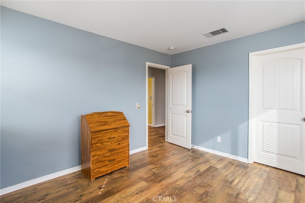 4423 Candelaria Way Perris, CA 92571 - Photo 27 of 42 a view of a room with wooden floor and closet