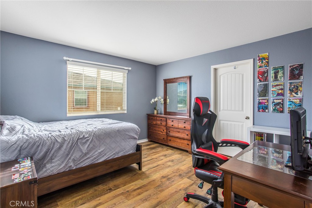 4423 Candelaria Way Perris, CA 92571 - Photo 29 of 42 a bedroom with a bed a dresser and a large window