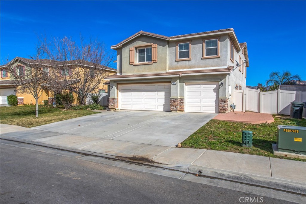 4423 Candelaria Way Perris, CA 92571 - Photo 4 of 42 a front view of a house with a yard and garage