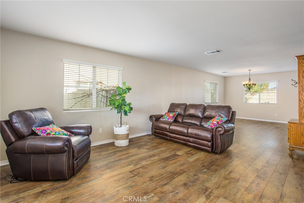 4423 Candelaria Way Perris, CA 92571 - Photo 7 of 42 a living room with furniture and wooden floor