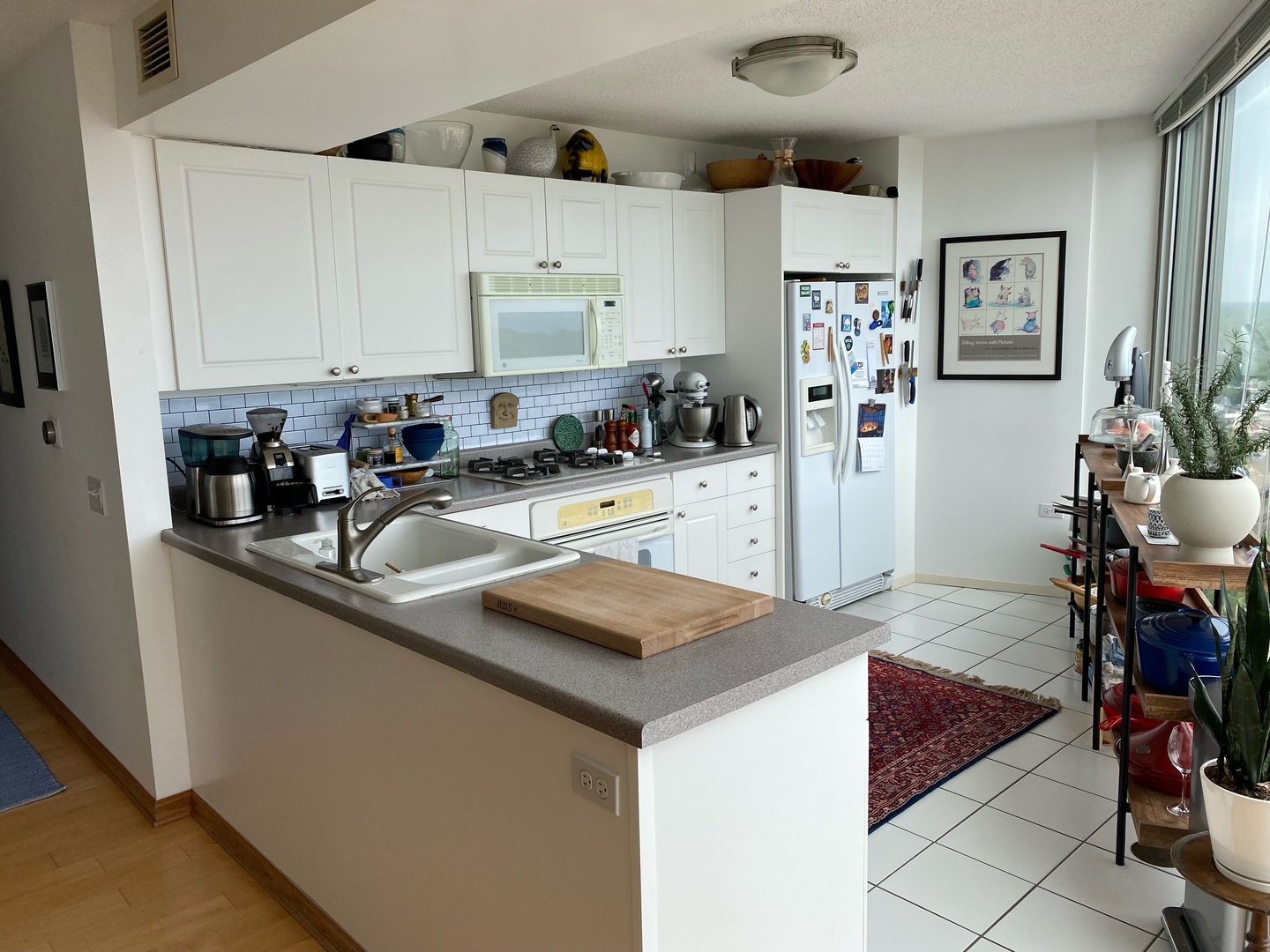 1720 Maple Avenue, Unit 2120 Evanston, IL 60201 - Photo 6 of 21 a kitchen with stainless steel appliances granite countertop a sink and a refrigerator