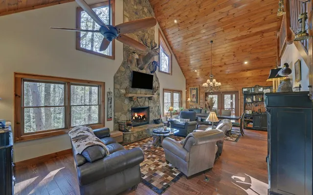 a living room with furniture and a chandelier