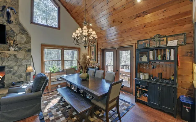a kitchen with a stove a sink dishwasher and a fireplace with wooden floor