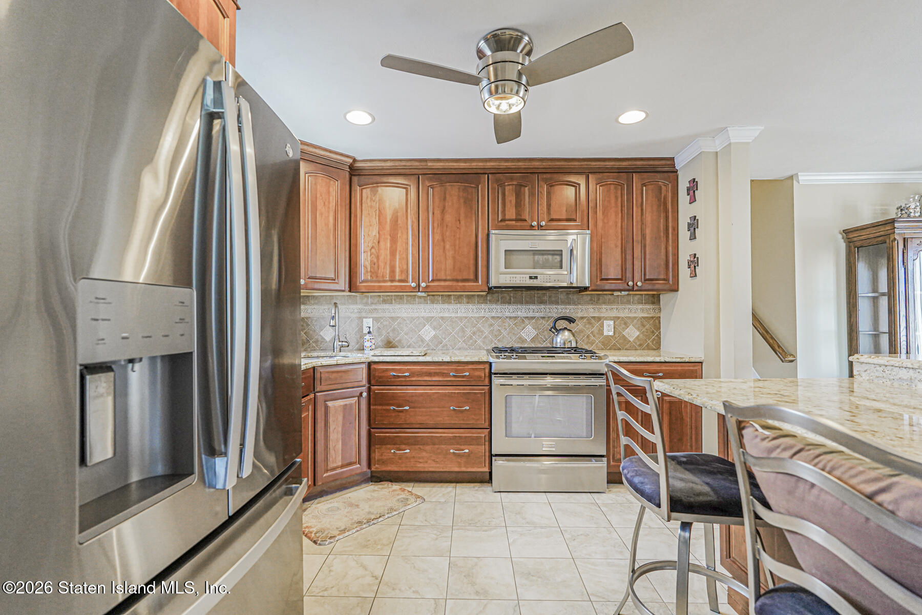 76 Berry Avenue Staten Island, NY 10312 - Photo 11 of 42 a kitchen with a stove a sink and a refrigerator