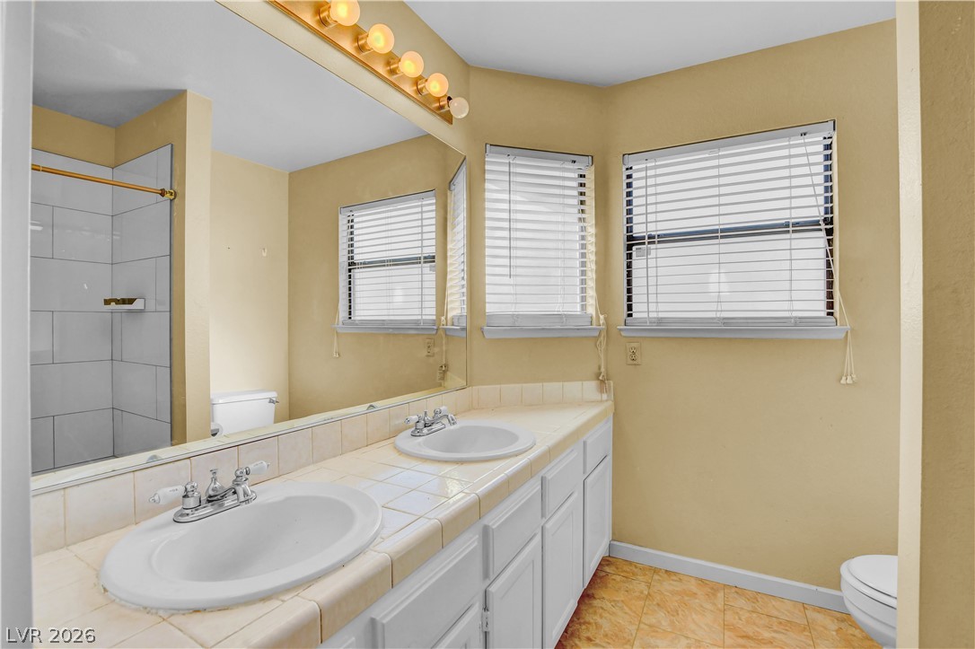 6440 Hartwood Road Las Vegas, NV 89108 - Photo 32 of 59 Double vanities and ample counter space create a functional and pleasant bathroom environment.