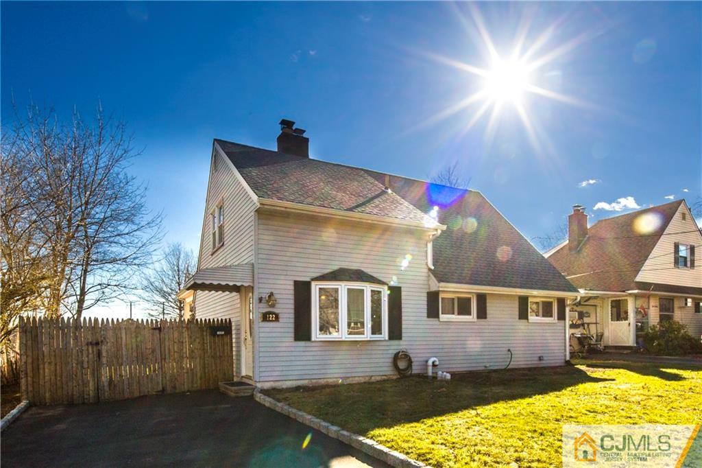 122 Ridge Road Colonia, NJ 07067 - Photo 1 of 25 a front view of a house with a yard