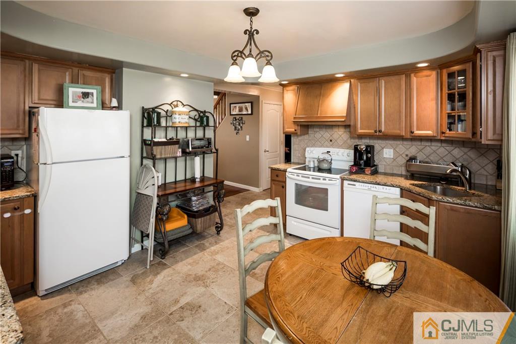 122 Ridge Road Colonia, NJ 07067 - Photo 11 of 25 a kitchen that has a table and chairs in it