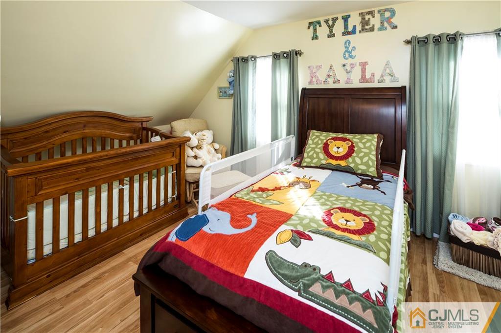 122 Ridge Road Colonia, NJ 07067 - Photo 16 of 25 a bedroom with a bed and a dresser