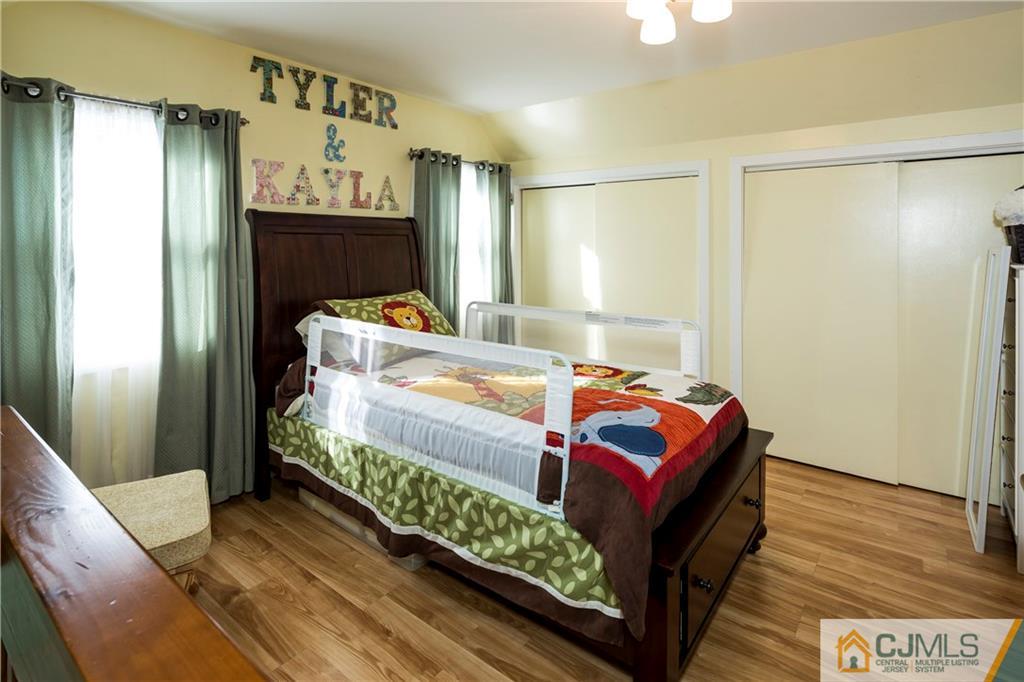 122 Ridge Road Colonia, NJ 07067 - Photo 17 of 25 a bedroom with a bed and wooden floor