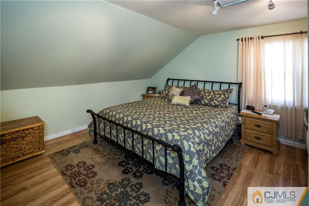 122 Ridge Road Colonia, NJ 07067 - Photo 19 of 25 a bedroom with a bed and wooden floor