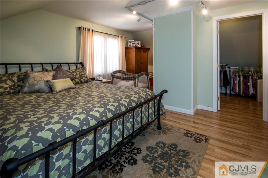 122 Ridge Road Colonia, NJ 07067 - Photo 20 of 25 a bedroom with a bed and a dresser
