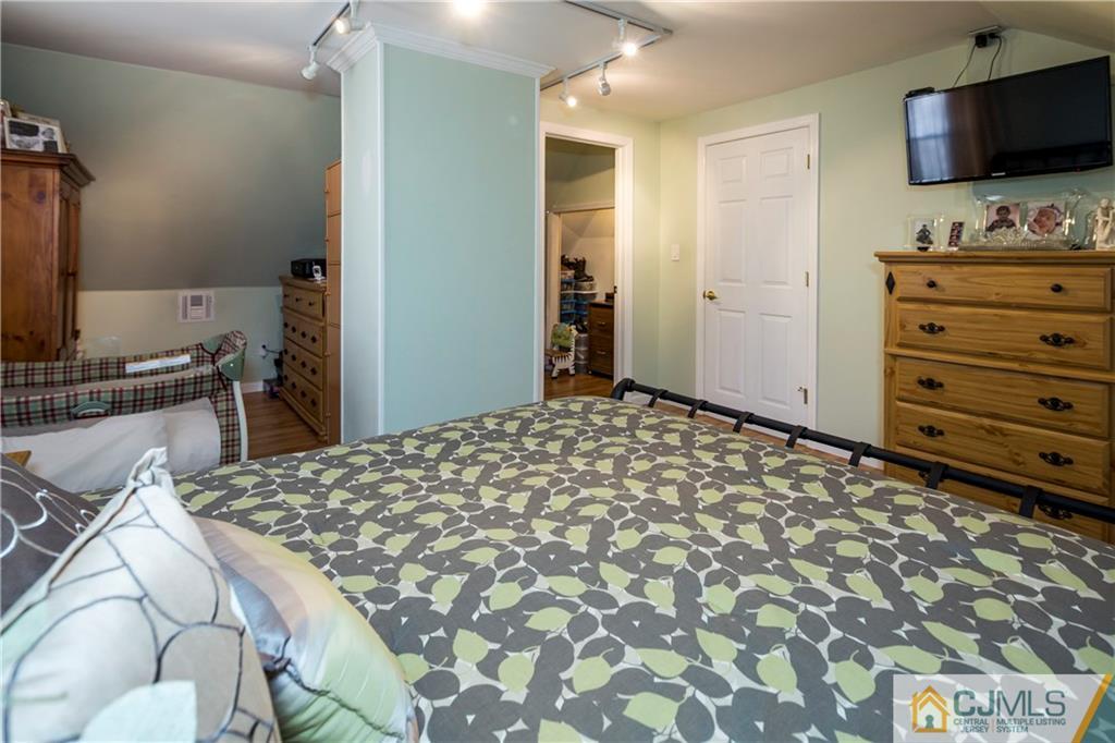 122 Ridge Road Colonia, NJ 07067 - Photo 21 of 25 a bedroom with a bed and a flat screen tv